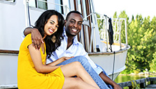 Couple sitting by yacht